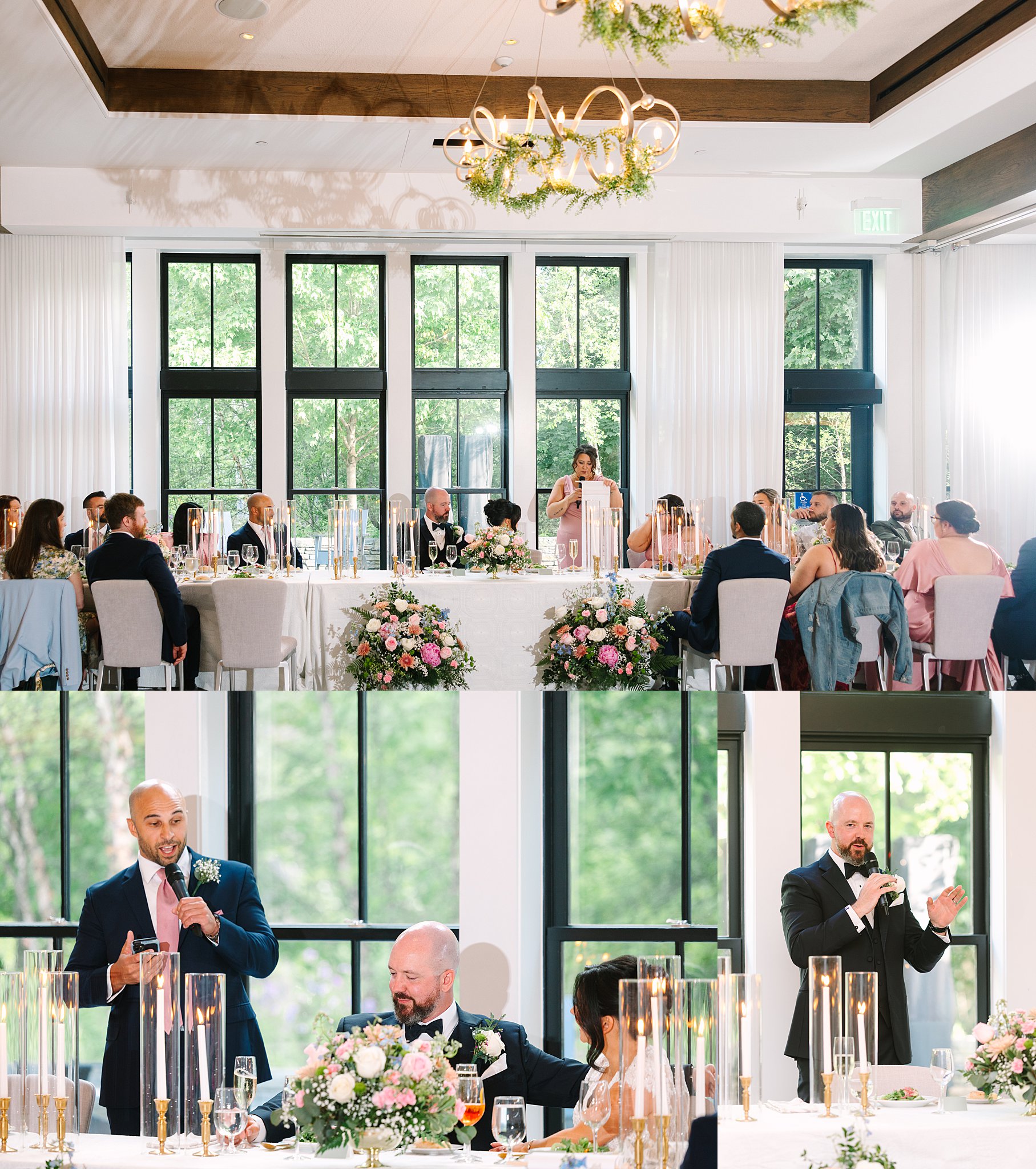 A wedding reception with guests seated at a long table decorated with flowers and candles. Two people are giving speeches using microphones, and a woman stands at a podium in the background.