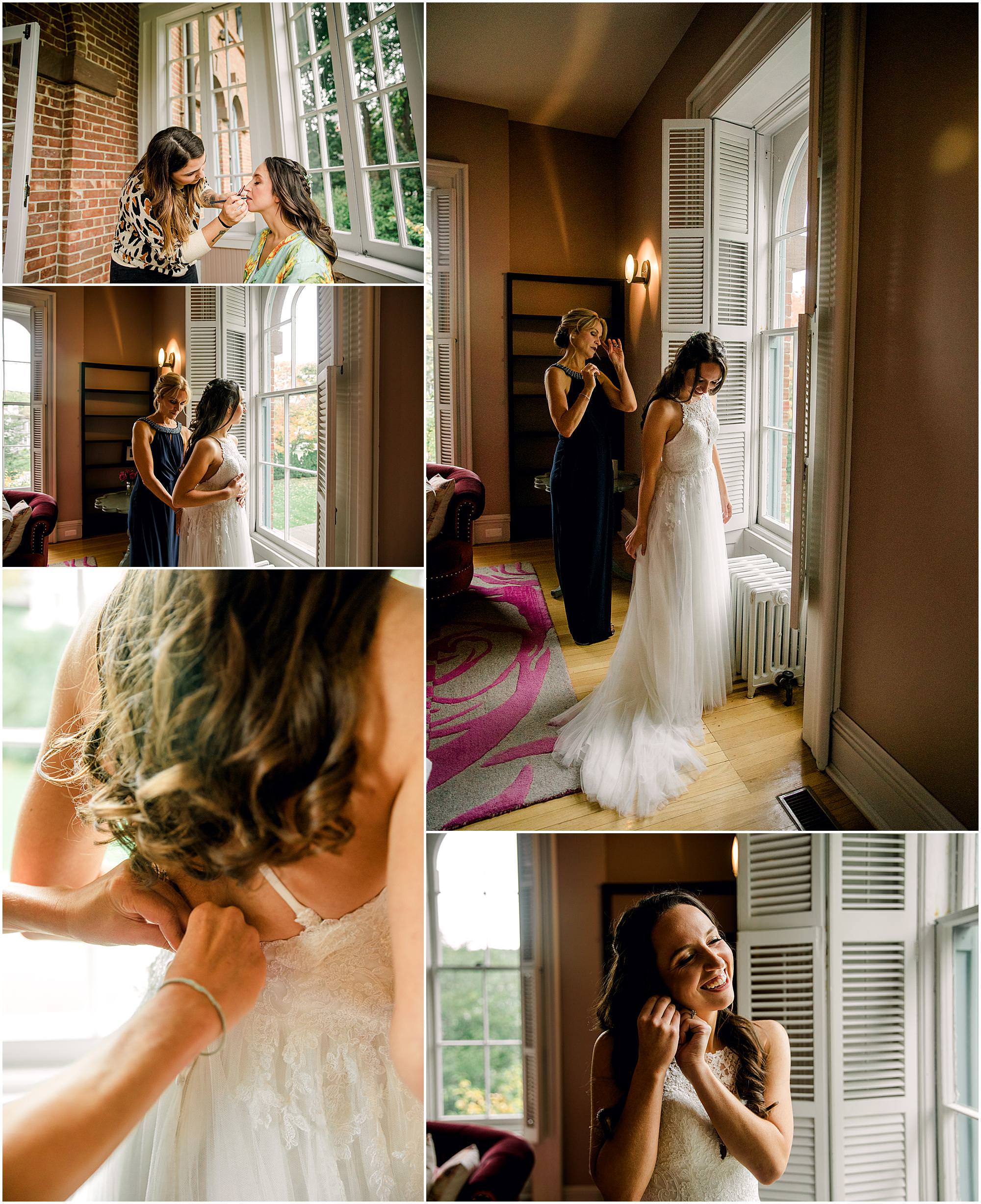 bride getting dressed for wedding in front of large window