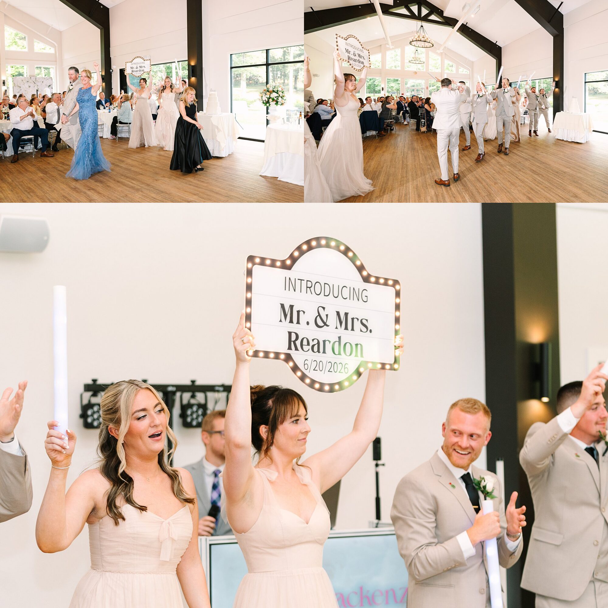 A bridal party in formal attire enters a bright wedding reception hall, cheering and holding a large sign that reads “Introducing Mr. & Mrs. Reardon 6/20/2026” while guests applaud.