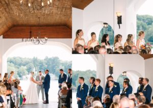 A wedding ceremony by a lake, with the bride and groom facing each other, bridesmaids in light dresses, and groomsmen in blue suits, surrounded by seated guests under a wooden ceiling.