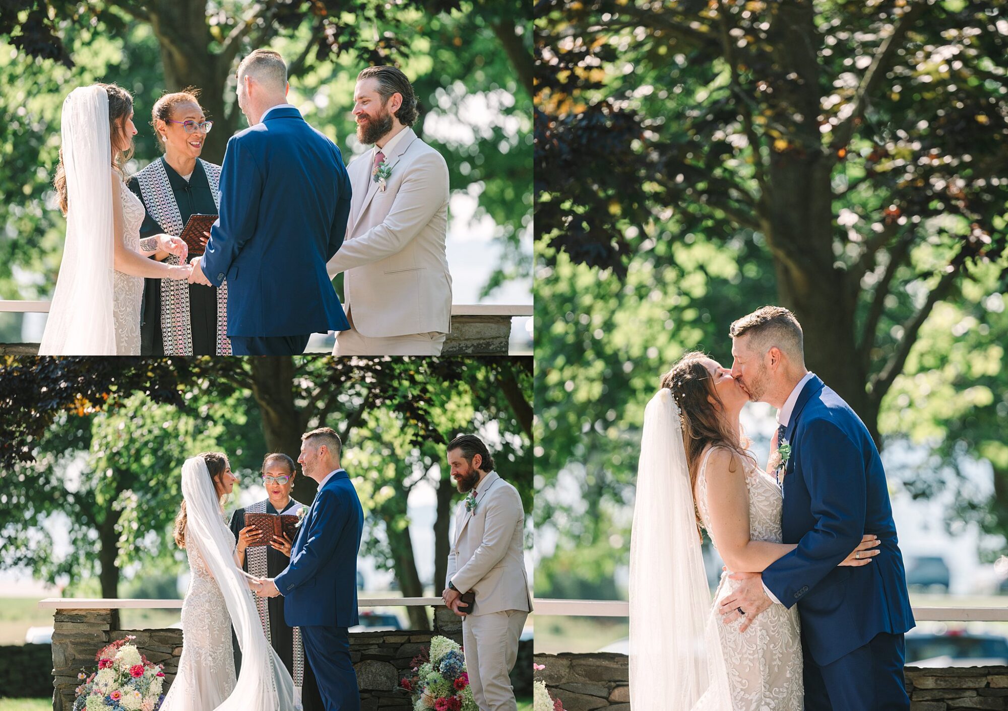 A bride and groom stand with an officiant outdoors, exchanging vows and sharing a kiss under sunlight, with a groomsman nearby.