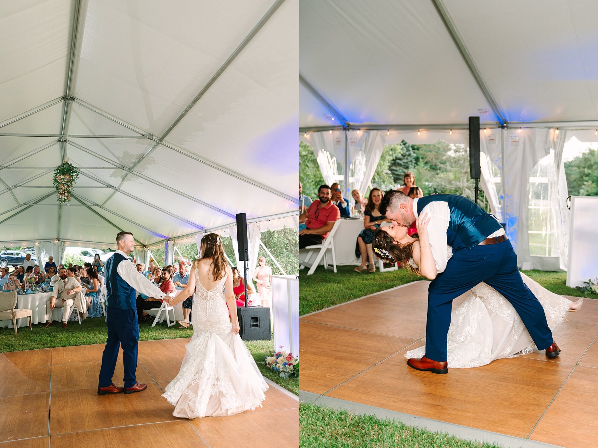 A bride and groom share their first dance under a white tent, watched by seated guests. The groom dips and kisses the bride on a wooden dance floor, surrounded by greenery and wedding decorations.