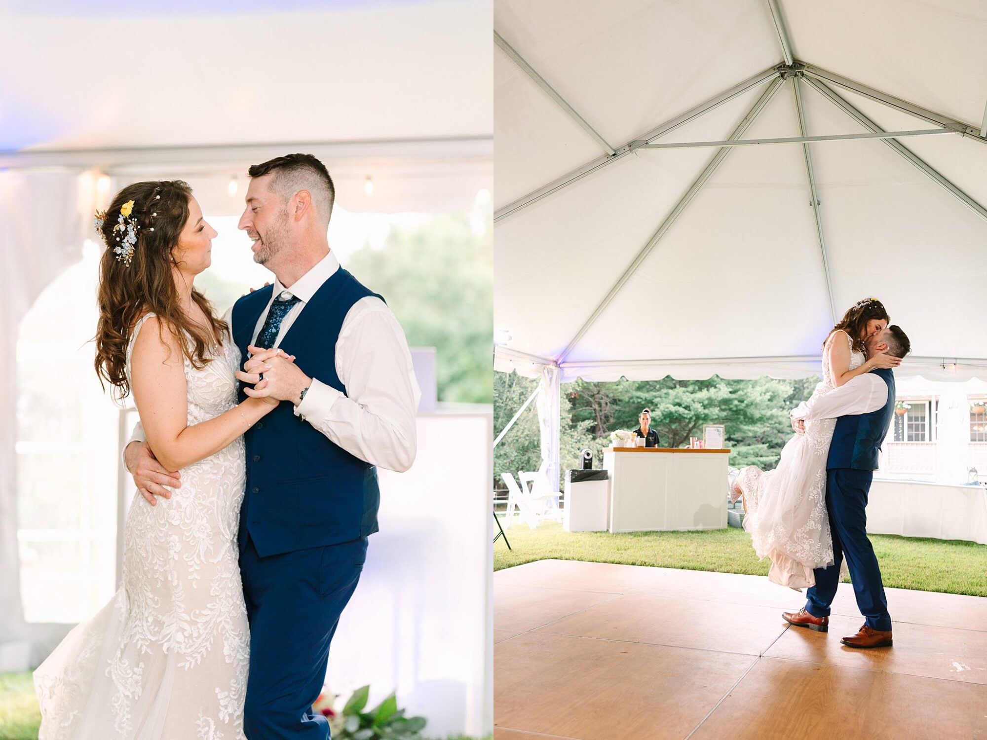 A bride and groom share their first dance under a white tent, smiling and holding each other closely. The groom lifts the bride as they dance on a wooden floor, surrounded by natural light and greenery.