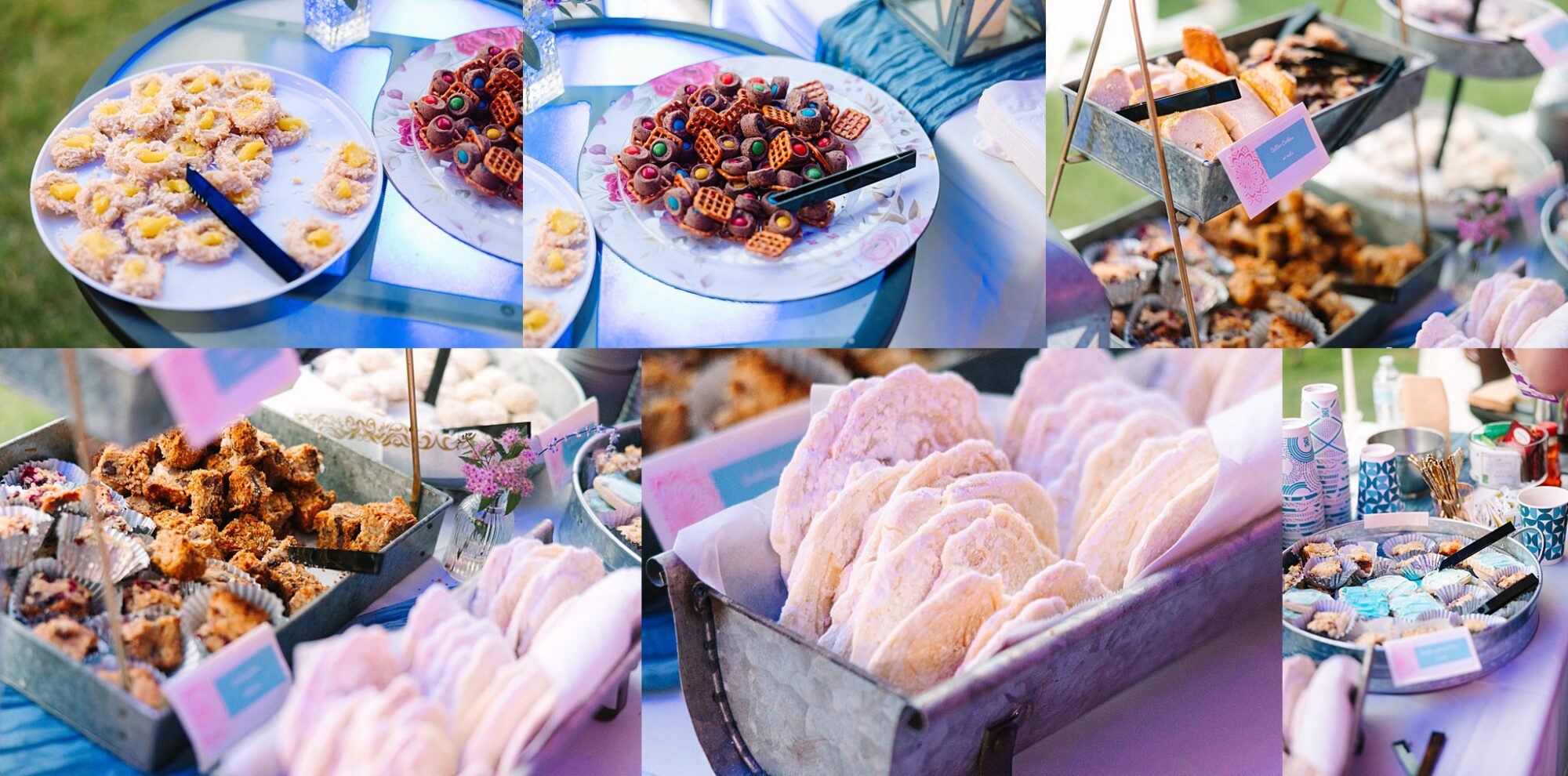 An assortment of desserts on trays, including cookies, bars, pretzels with chocolate candies, and powdered treats, displayed on a table at an outdoor event with colorful lighting.